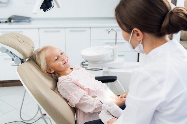 image-little-girl-having-her-teeth-checked-by-doctor